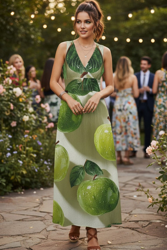 Woman wearing a green dress with apple pattern in an outdoor setting