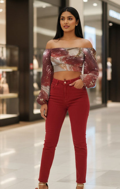Woman in a metallic off-shoulder top and red pants standing in a mall.