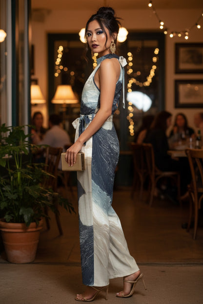 Woman in a patterned jumpsuit standing in a restaurant setting