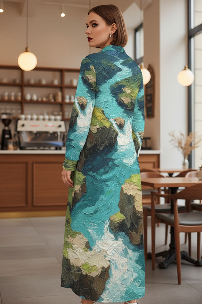 Woman wearing a long, colorful dress with a nature-themed design in a cafe.